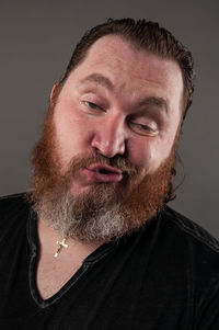 Close-up portrait of a man against black background