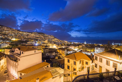 High angle view of illuminated buildings in city at night