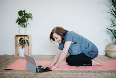 Senior woman using laptop at home