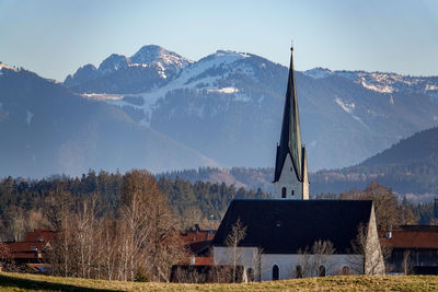 Panoramic view of building and mountains against sky