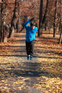 Man jogging at public park during autumn