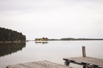 Pier on lake against sky