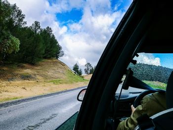 Panoramic view of road seen through car windshield