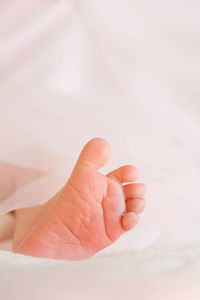 Close-up of baby sleeping on bed