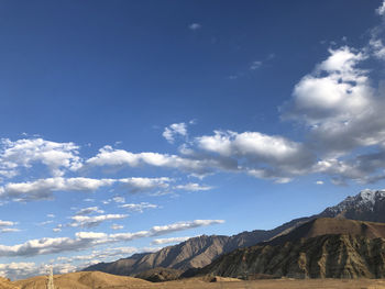 Scenic view of mountains against blue sky