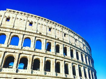 Low angle view of historical building against clear blue sky