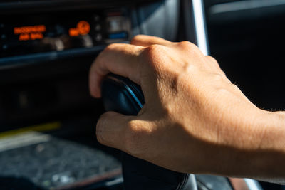 Cropped hand of man using car
