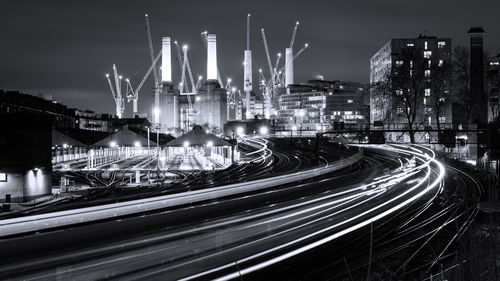 Light trails on street against sky at night