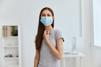 Portrait of beautiful young woman standing at home