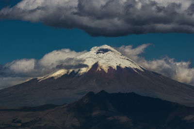 Low angle view of snowcapped mountains against sky