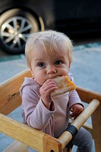 Portrait of cute baby sitting on seat
