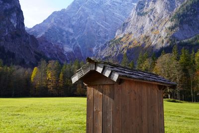 Built structure on field against mountain range