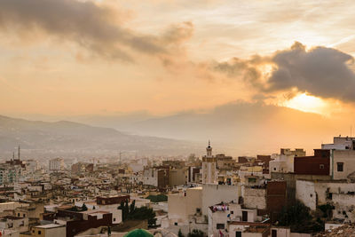 Cityscape against sky during sunset