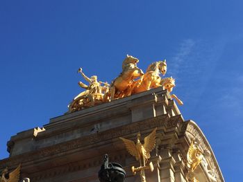 Low angle view of golden statue on cascada fountain