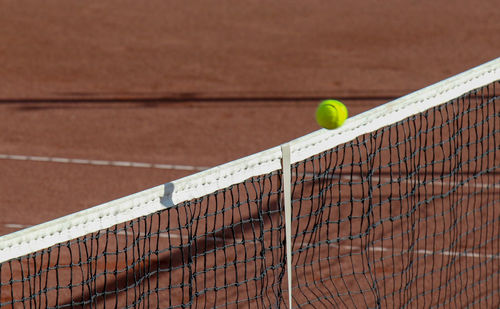 High angle view of ball over net at tennis court