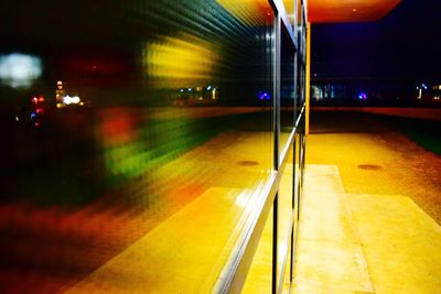 Illuminated railroad station platform at night