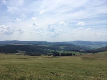 Scenic view of landscape against cloudy sky