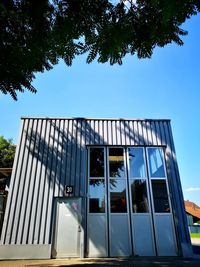 Low angle view of building against clear blue sky