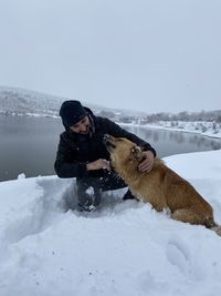 Man with dog on snow