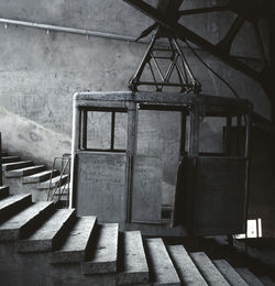 Graffiti on abandoned overhead cable car amidst steps