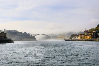 View of bridge over river in city