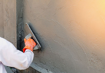 High angle view of man working on wall