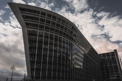 Low angle view of office building against sky