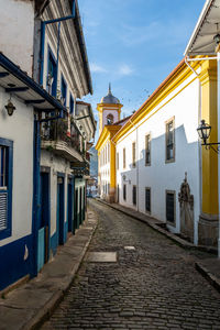 Street amidst buildings against sky in city