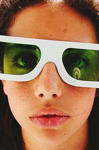 Close-up portrait of teenage girl wearing 3-d glasses