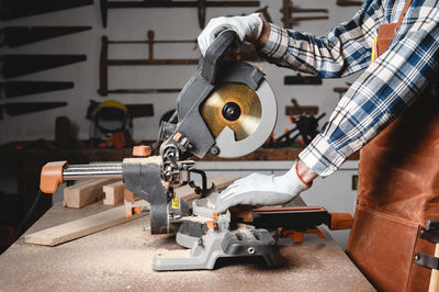 Midsection of man working in workshop