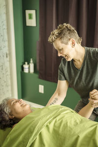 Young man lying down on bed