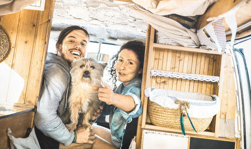 Portrait of happy couple in camper van