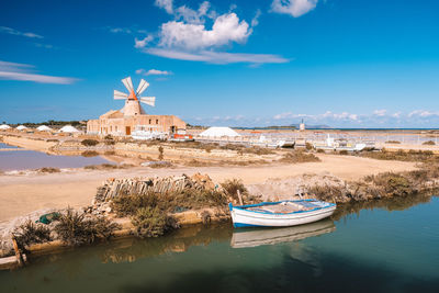 Built structure by sea against blue sky