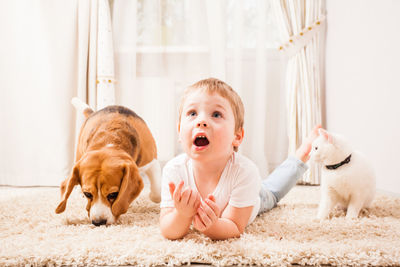 Boy with cat and dog at home