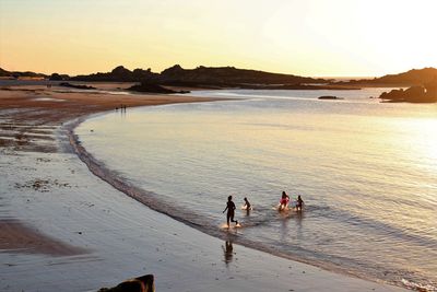 High angle view of mother with children at beach