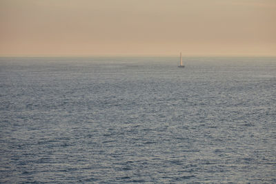 Scenic view of sea against clear sky during sunset