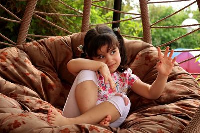 Low angle view of woman sitting on hammock