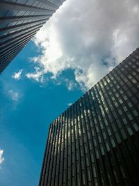 Low angle view of modern building against cloudy sky