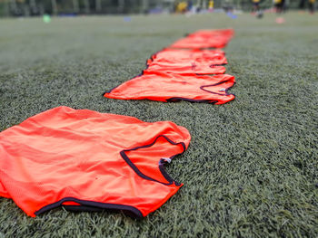 Close-up of red soccer ball on field