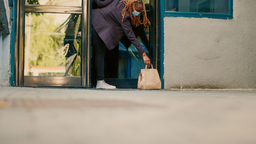 Low section of woman standing on street