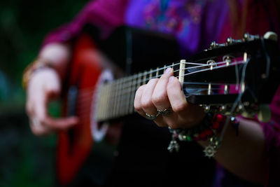 Cropped image of man playing guitar