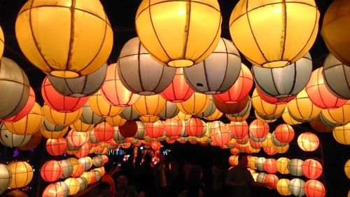 Low angle view of illuminated lanterns hanging at night