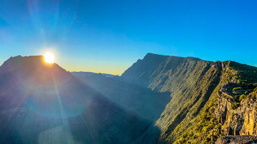 Scenic view of mountains against blue sky
