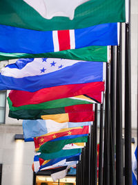 Multi colored flags against blue sky