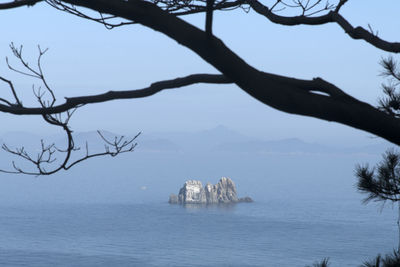 Scenic view of sea and mountains against sky