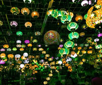 Low angle view of illuminated lanterns hanging at night