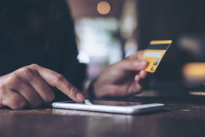 Midsection of businesswoman making payment through technologies