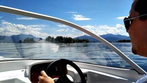 Cropped image of boat sailing in sea