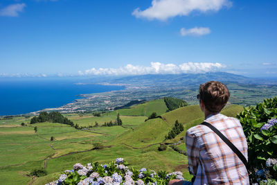 Rear view of person looking at landscape