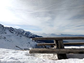 Snow covered land against sky